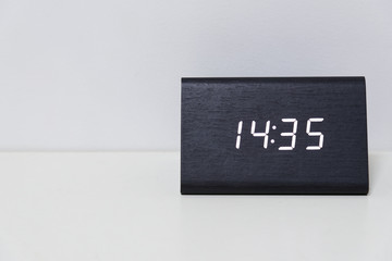 Black digital clock on a white background showing time 14:35