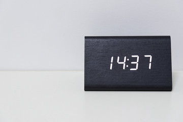 Black digital clock on a white background showing time 14:37