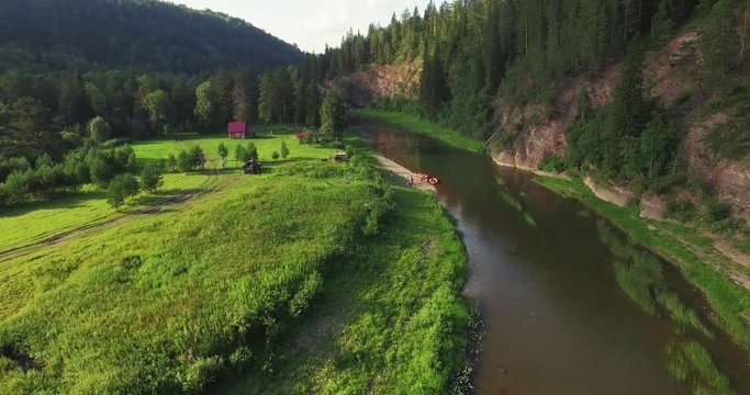 Epic Rafting Two Orange Boat on Shallow Mountain Forest Zilim River in Ural Mountains, Russia at summer sunny day - Aerial view