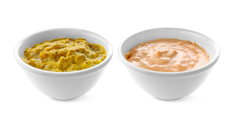 Tasty sauces in bowls on white background
