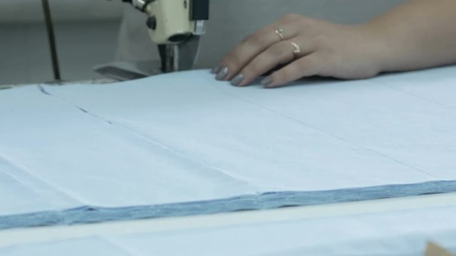 Cutting the fabric, sewing work. Cutting room, cutting blue cloth tailoring knife.