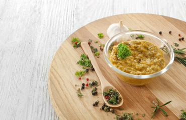 Tasty sauce in bowl with spices on wooden board