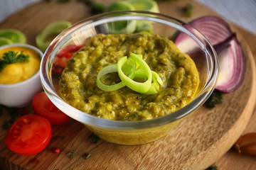 Tasty sauce in bowl on wooden board