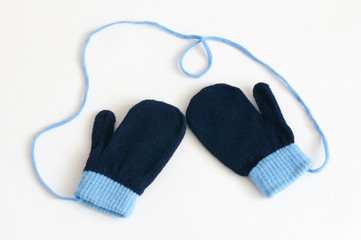 Blue knitted mittens on a white background