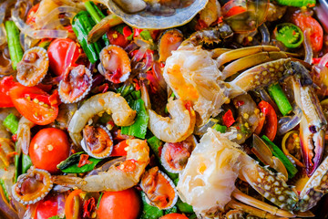 Som Tam Seafood (Spicy Papaya Salad) with salted crab, on wooden table ( Thai food)