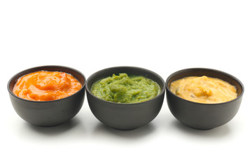 Different tasty sauces in bowls on white background