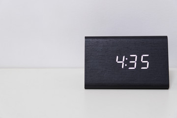 Black digital clock on a white background showing time 4:35