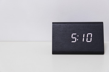 Black digital clock on a white background showing time 5:10