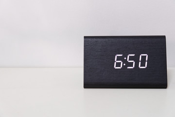 Black digital clock on a white background showing time 6:50