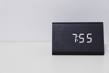Black digital clock on a white background showing time 7:55