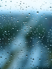 Raindrops on the glass. Close-up of natural water drops on vertical glass texture