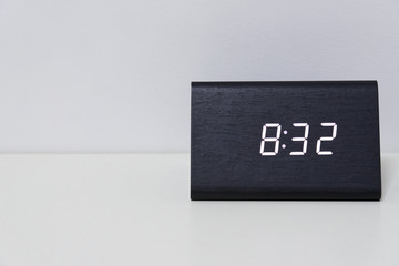 Black digital clock on a white background showing time 8:32