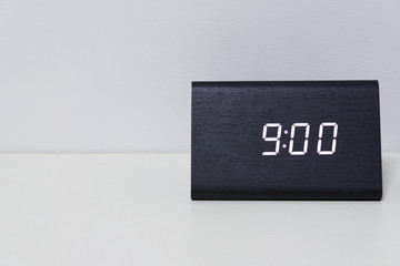 Black digital clock on a white background showing time 9:00