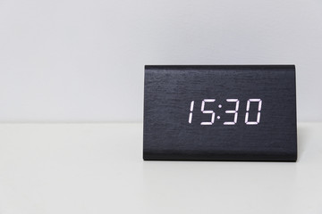 Black digital clock on a white background showing time 15:30