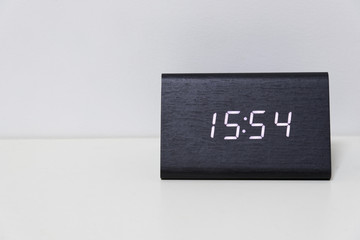 Black digital clock on a white background showing time 15:54