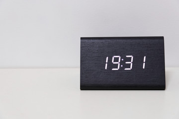 Black digital clock on a white background showing time 19:31