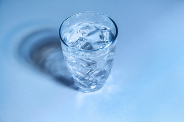 Glass of fresh cool water on table