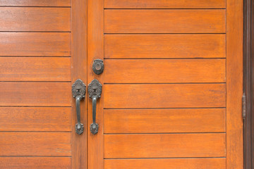 Close up of wooden brown door. Background and texture of wooden door.