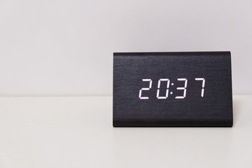 digital table clock showing 20:37 time