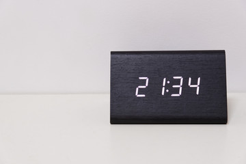 digital table clock showing 21:34 time