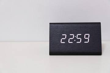 digital table clock showing 22:59 time