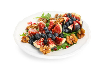 Delicious fresh salad with walnuts on plate, isolated on white