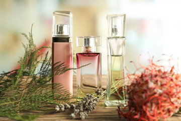 Bottles of floral perfume on wooden table