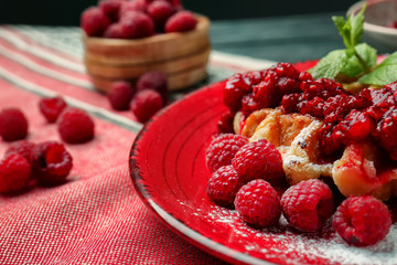 Tasty waffles with berries on plate, closeup