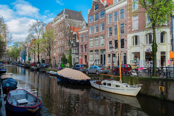 Fototapeta na wymiar Facades of dutch houses over small canal, Amstardam scenery, Netherlands