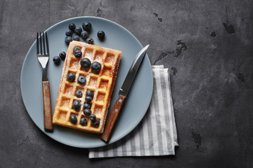 Tasty waffle with berries on plate