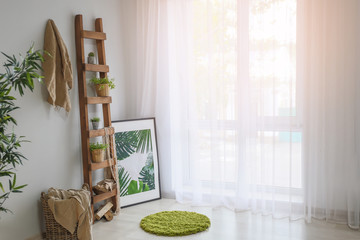 Room interior in eco style with ladder and green plants