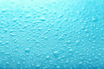 Drops of water on color background