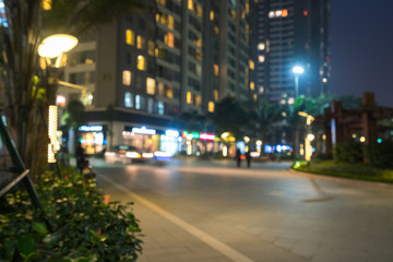Fototapeta na wymiar Blurred modern urban city at night with street traffic