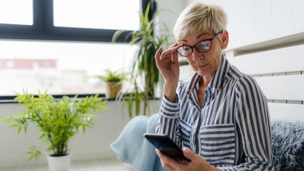 Senior woman using digital tablet at home. The use of technology by the elderly.