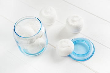 white zephyr on white wooden background. marshmallow in decorative glass jar