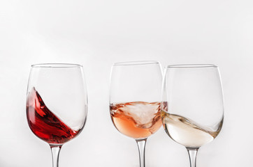 Glasses of different wine on white background