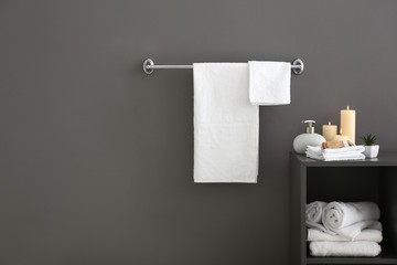White bath towels near grey wall