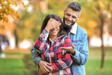 Fototapeta premium Young man proposing to his beloved in autumn park