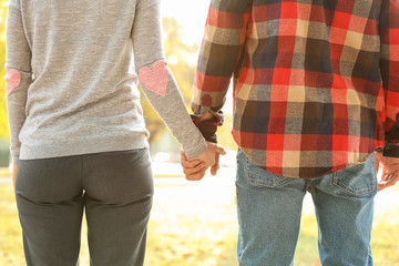 Loving young couple holding hands outdoors