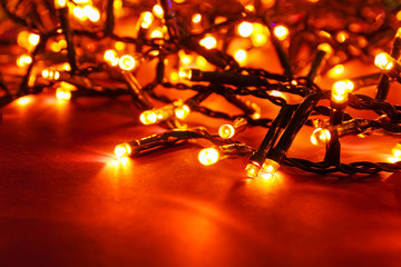 Glowing Christmas lights on color background