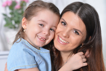 Portrait of happy little girl with mother