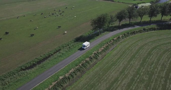 Aerial shot of a motorhome driving in a local road.