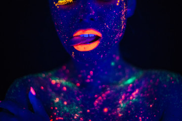 Portrait of Beautiful Fashion Woman in Neon UF Light. Model Girl with Fluorescent Creative Psychedelic MakeUp, Art Design of Female Disco Dancer Model in UV, Colorful Abstract Make-Up