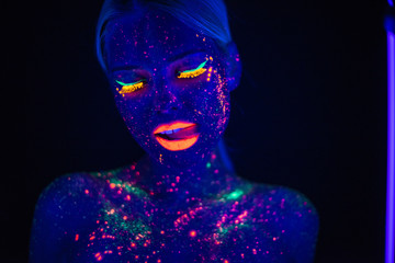 Portrait of Beautiful Fashion Woman in Neon UF Light. Model Girl with Fluorescent Creative Psychedelic MakeUp, Art Design of Female Disco Dancer Model in UV, Colorful Abstract Make-Up
