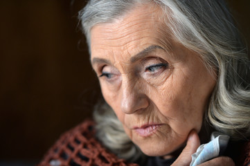 Close up portrait of tired senior woman posing