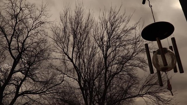 Wind chimes blowing in the winter air.