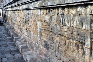 Reliefs on a corridor wall. Borobudur Buddhist Temple, Magelang Regency, Java, Indonesia