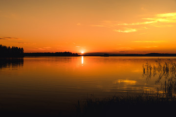 Beautiful bright orange sunset across a lake in Sweden