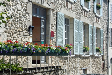 Fototapeta na wymiar Façade et balcon fleurie, volets bleus, ville de Beaugency, Val de Loire, département du Loiret, France