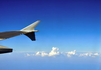 Fototapeta premium Clouds under the airplane's wing